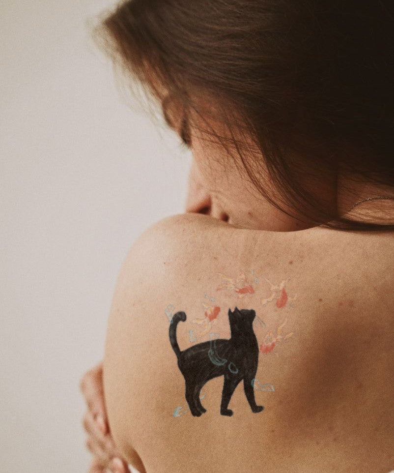 Black Cat & Floral Splash hand-drawn temporary tattoo — botanical line work, suited for forearm placement. Waterproof, plant-based, 3–7 day wear. By LastingDays indie artist collective.