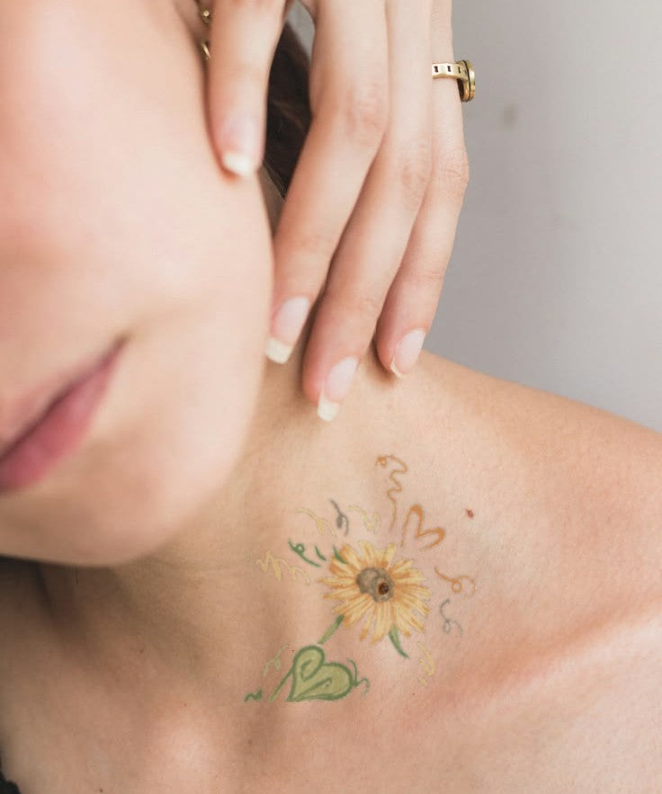 Sunflower Joy hand-drawn temporary tattoo — botanical line work, suited for below collarbone placement. Waterproof, plant-based, 3–7 day wear. By LastingDays indie artist collective.