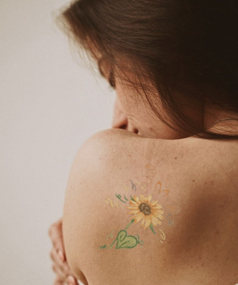 Sunflower Joy hand-drawn temporary tattoo — botanical line work, suited for below collarbone placement. Waterproof, plant-based, 3–7 day wear. By LastingDays indie artist collective.