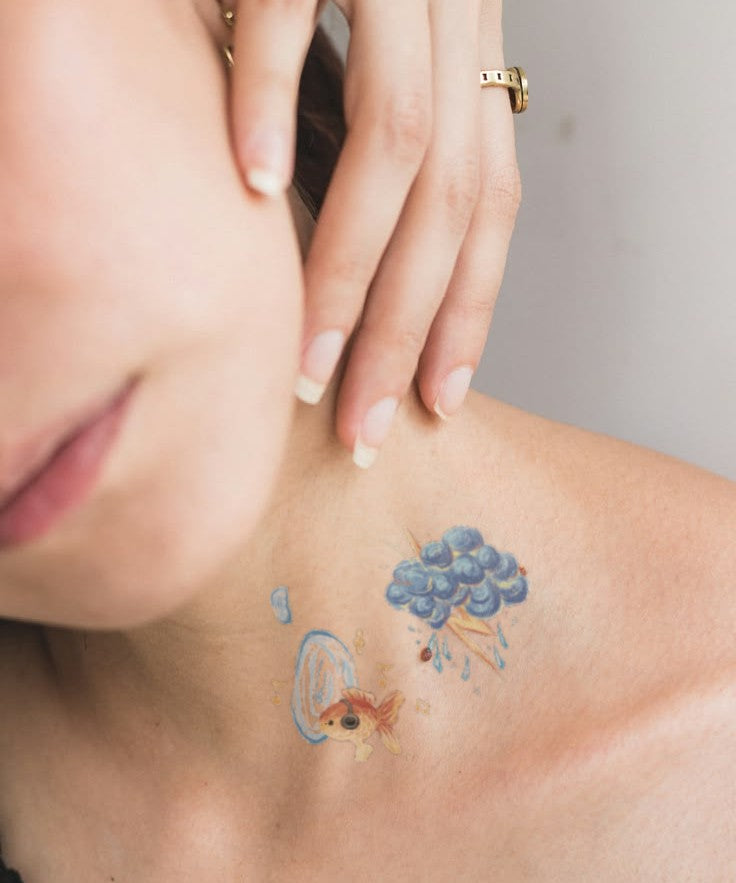 Forget-Me-Not & Goldfish hand-drawn temporary tattoo — botanical line work, suited for forearm placement. Waterproof, plant-based, 3–7 day wear. By LastingDays indie artist collective.