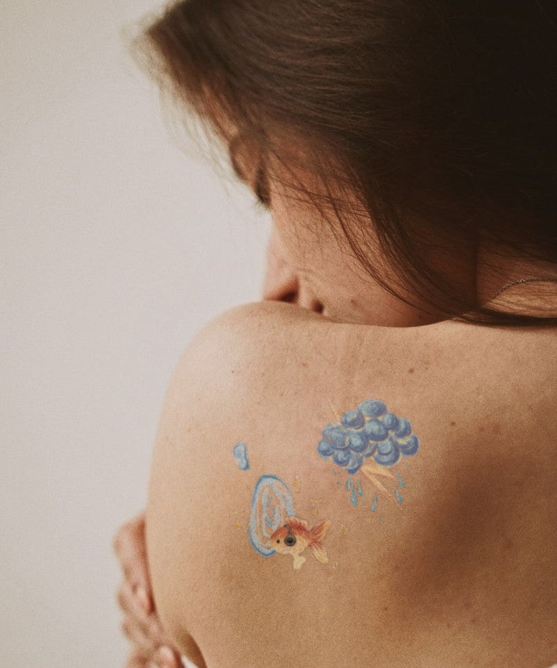 Forget-Me-Not & Goldfish hand-drawn temporary tattoo — botanical line work, suited for forearm placement. Waterproof, plant-based, 3–7 day wear. By LastingDays indie artist collective.