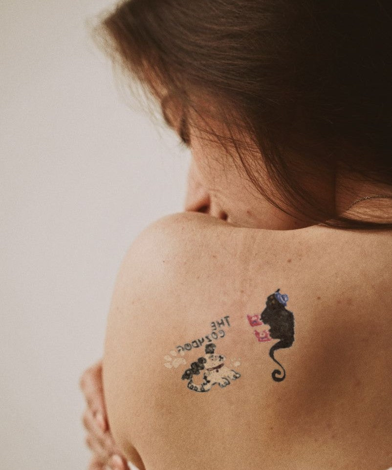 Mysterious Cat Parade hand-drawn temporary tattoo — animal subject, suited for forearm placement. Waterproof, plant-based, 3–7 day wear. By LastingDays indie artist collective.