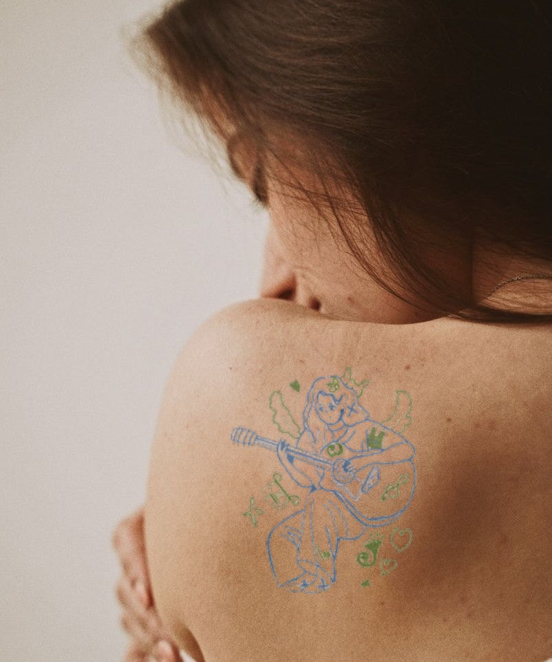 Music Girl with Guitar hand-drawn temporary tattoo — anime illustration style, suited for forearm placement. Waterproof, plant-based, 3–7 day wear. By LastingDays indie artist collective.