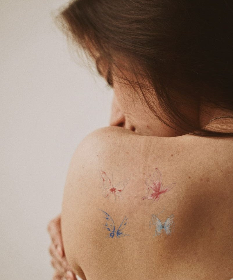 Floating Blue Butterflies hand-drawn temporary tattoo — wing motif, suited for forearm placement. Waterproof, plant-based, 3–7 day wear. By LastingDays indie artist collective.