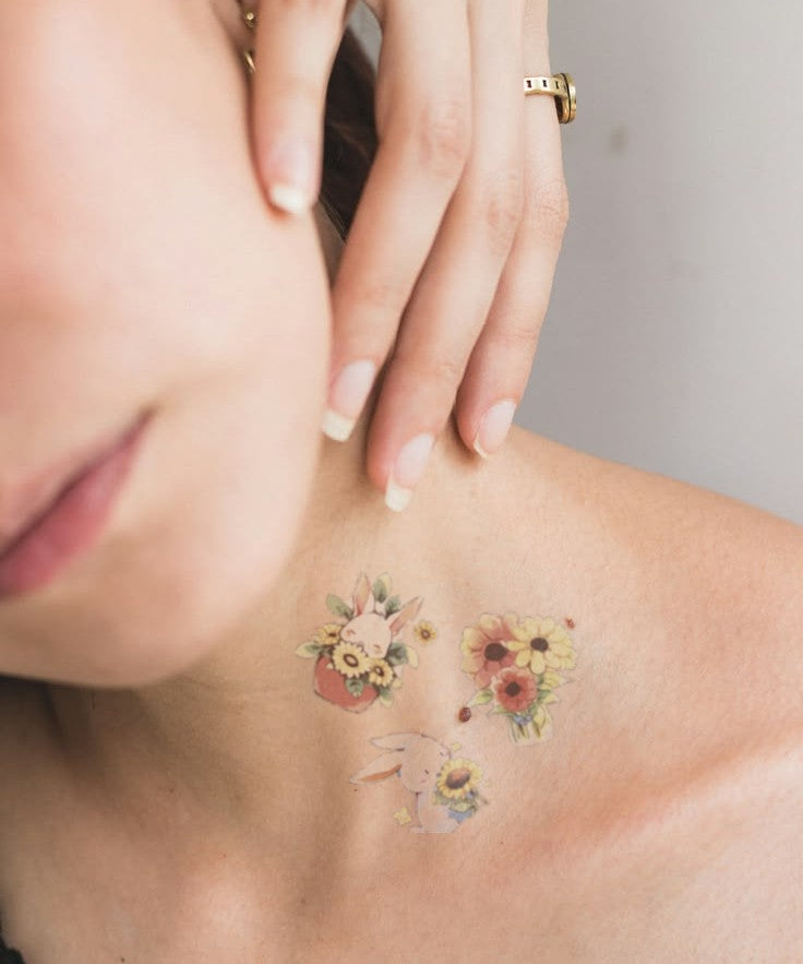 Sunflower Bunny Garden hand-drawn temporary tattoo — botanical line work, suited for below collarbone placement. Waterproof, plant-based, 3–7 day wear. By LastingDays indie artist collective.