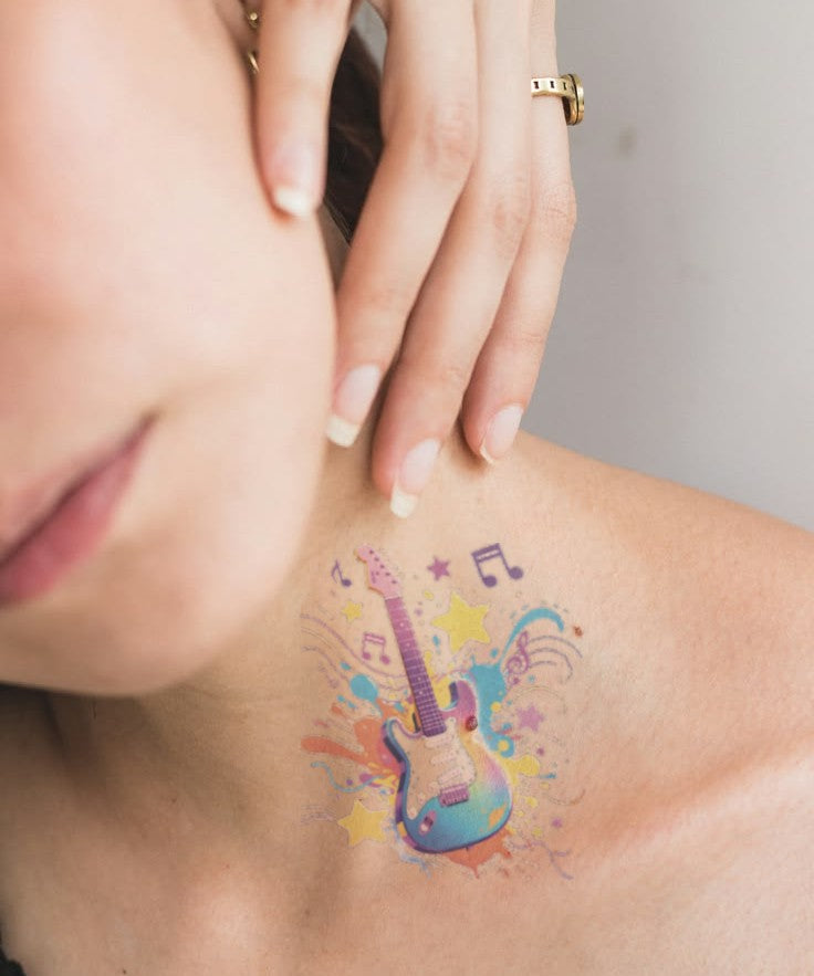Rock Star Guitar hand-drawn temporary tattoo — celestial design, suited for collarbone placement. Waterproof, plant-based, 3–7 day wear. By LastingDays indie artist collective.