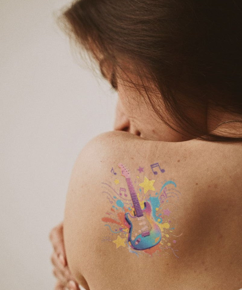 Rock Star Guitar hand-drawn temporary tattoo — celestial design, suited for collarbone placement. Waterproof, plant-based, 3–7 day wear. By LastingDays indie artist collective.