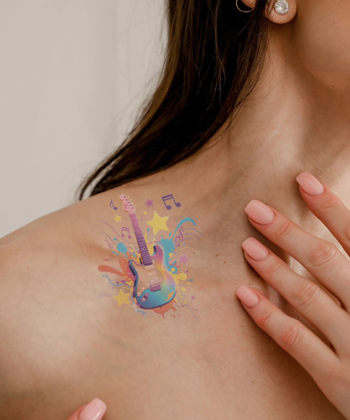 Rock Star Guitar hand-drawn temporary tattoo — celestial design, suited for collarbone placement. Waterproof, plant-based, 3–7 day wear. By LastingDays indie artist collective.