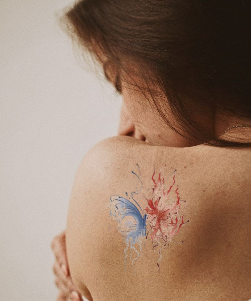 Blue Flame Butterfly hand-drawn temporary tattoo — wing motif, suited for shoulder placement. Waterproof, plant-based, 3–7 day wear. By LastingDays indie artist collective.
